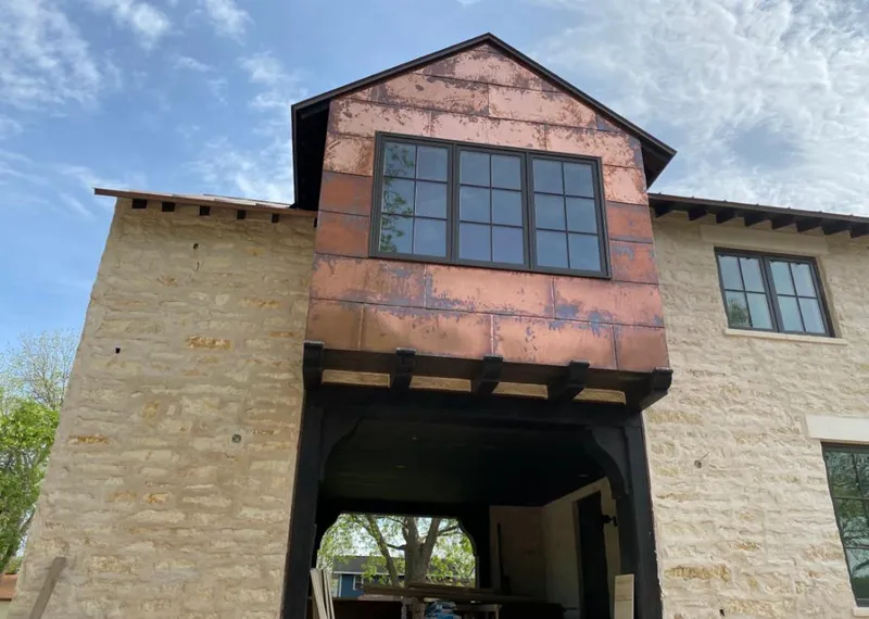 Copper metal panel facade on a stone building for Skylight Installation in Bloomington